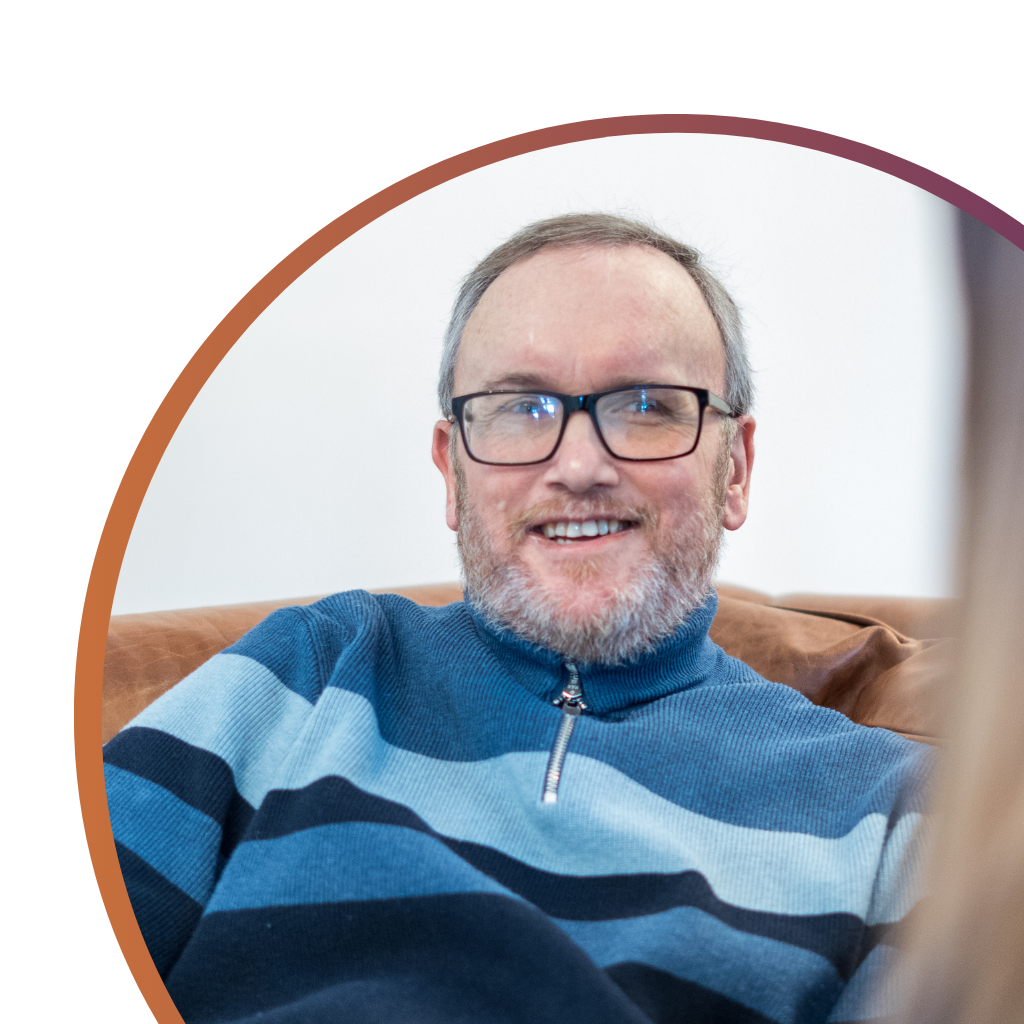 Service user with complex needs sharing his story, smiling and happy, demonstrating resilience and thriving with support from Komplex Community after a brain injury.