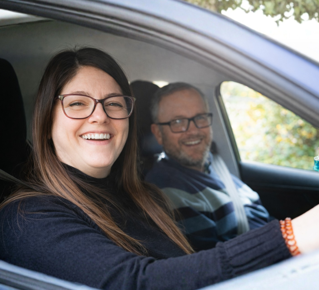 Care worker supporting a client during an outing, showing improved confidence.